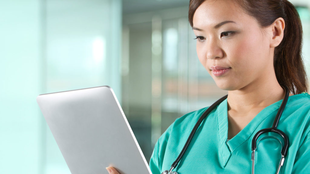 Portrait of a Female doctor holding a digital tablet.